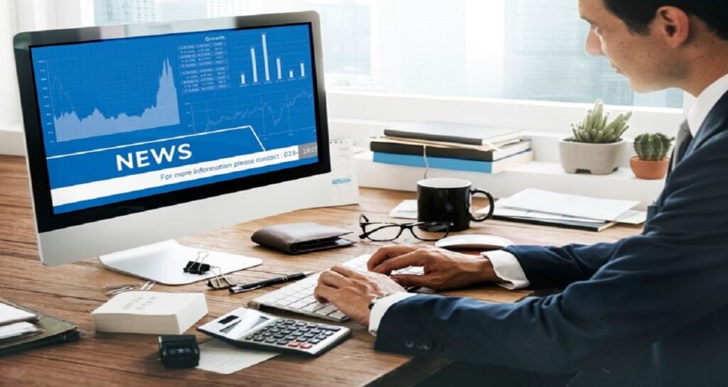 man looking stock market news computer 53876 122481
